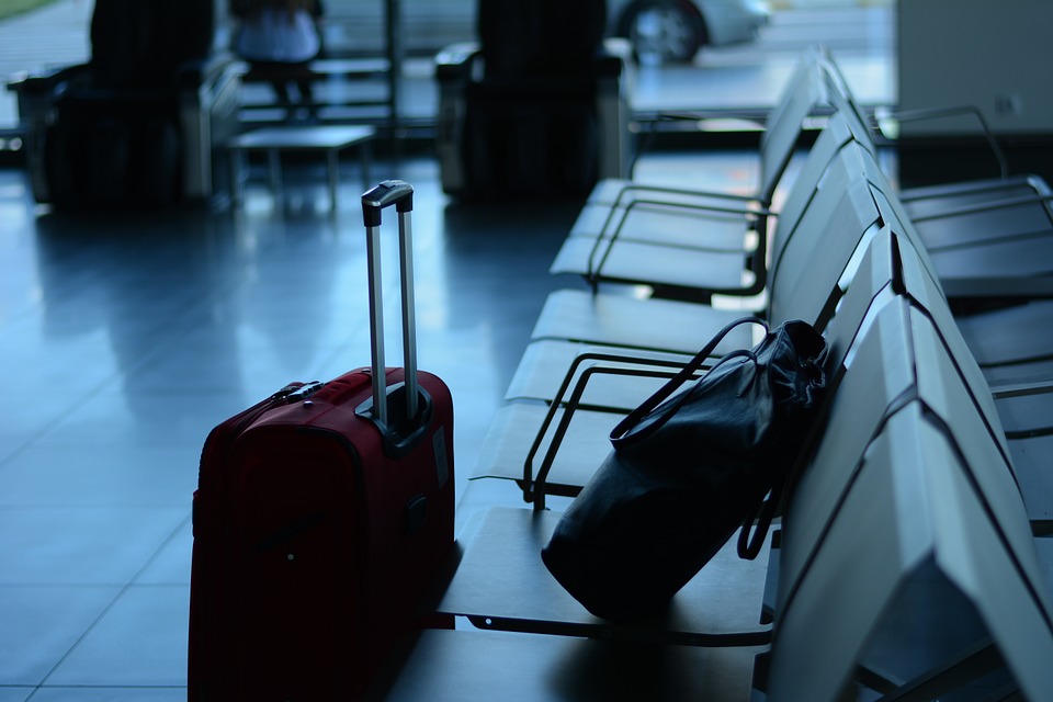 two carry-on bags at a terminal.